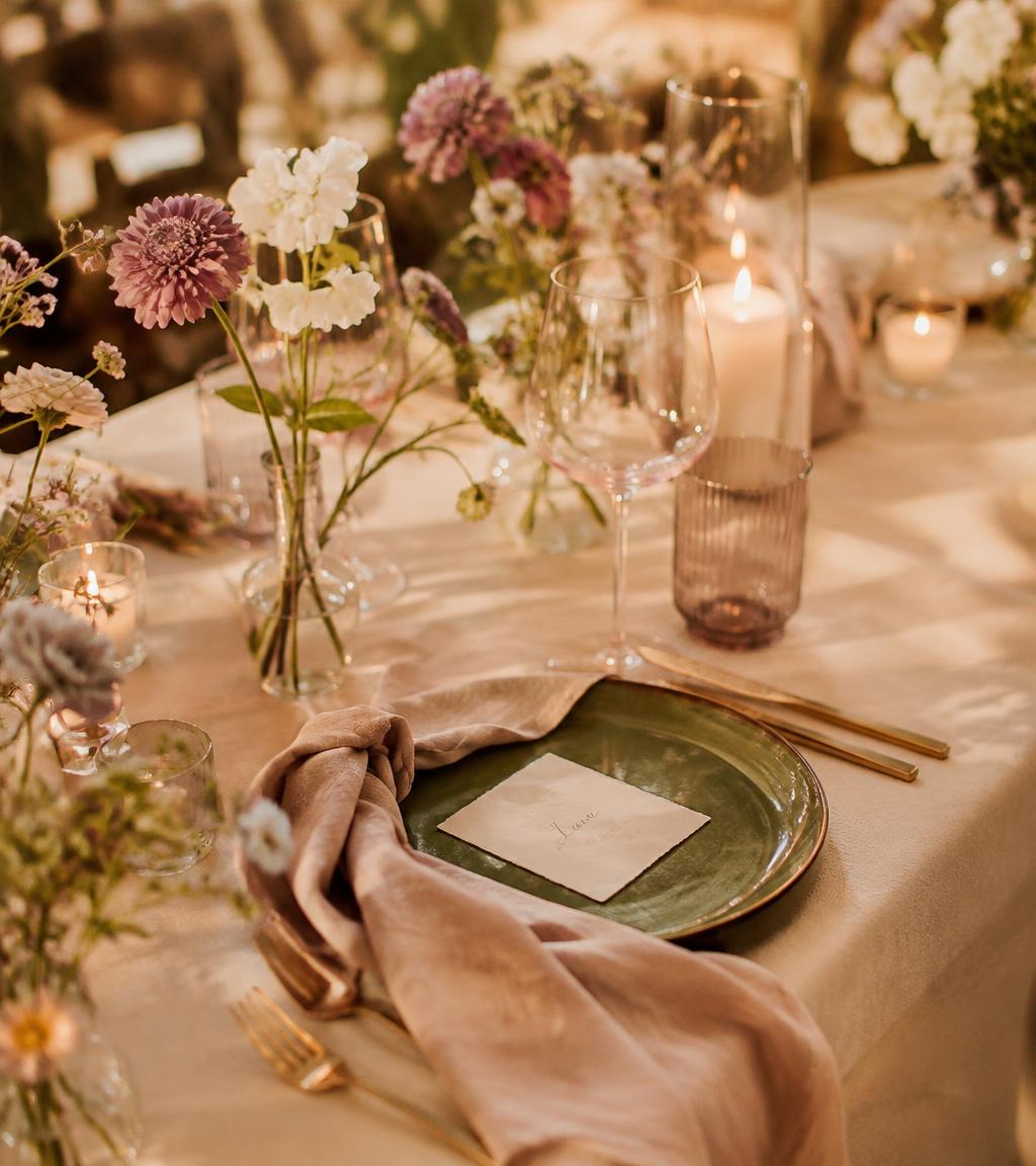 Wedding table with blush napkin, olive plate and a handwritten place card